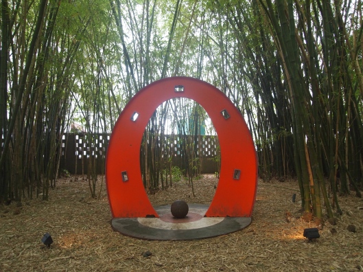 a sculpture in a bamboo grove